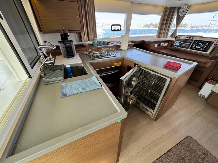 La Vigie Yacht Photos Pics Modern kitchen interior of 2018 Lagoon 450 F catamaran with appliances and sea view.