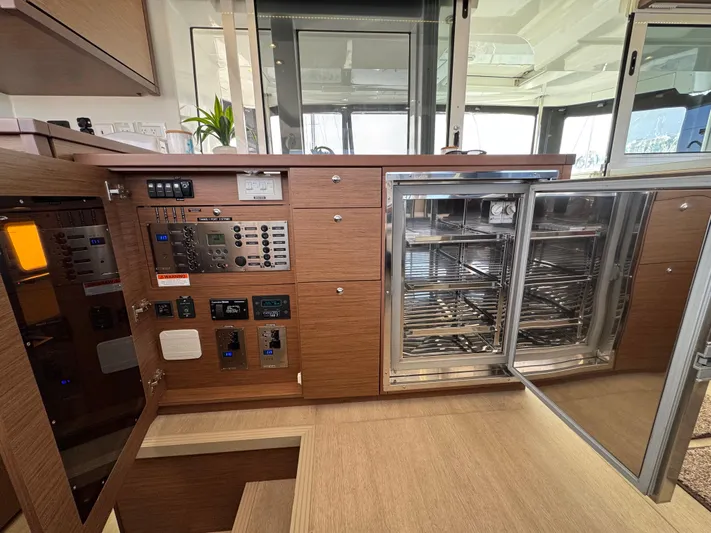 La Vigie Yacht Photos Pics Interior of 2018 Lagoon 450 F yacht showing control panel and open stainless steel fridge.