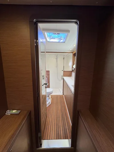 La Vigie Yacht Photos Pics Interior view of 2018 Lagoon 450 F yacht bathroom with wooden accents and skylight.