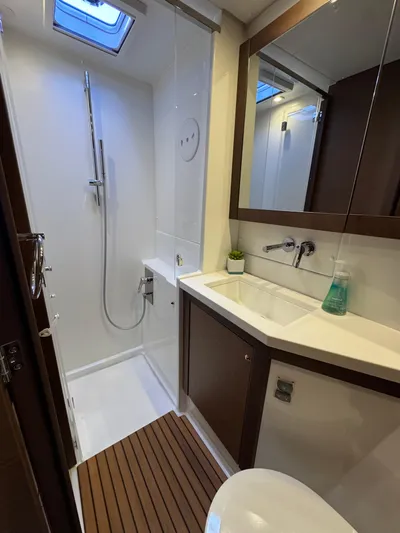 La Vigie Yacht Photos Pics Modern bathroom in 2018 Lagoon 450 F yacht with shower and wooden accents.