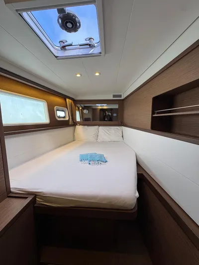La Vigie Yacht Photos Pics Luxurious cabin interior of 2018 Lagoon 450 F catamaran with skylight and cozy bedding.