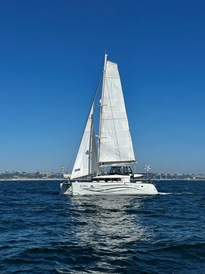 La Vigie Yacht Photos Pics 2018 Lagoon 450 F catamaran sailing on open water under clear blue skies.