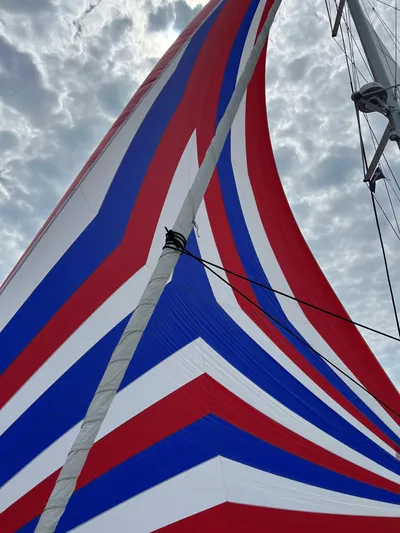 La Vigie Yacht Photos Pics Colorful sail of 2018 Lagoon 450 F against cloudy sky.