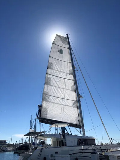 La Vigie Yacht Photos Pics 2018 Lagoon 450 F sailboat with sunlit sails against a clear blue sky.
