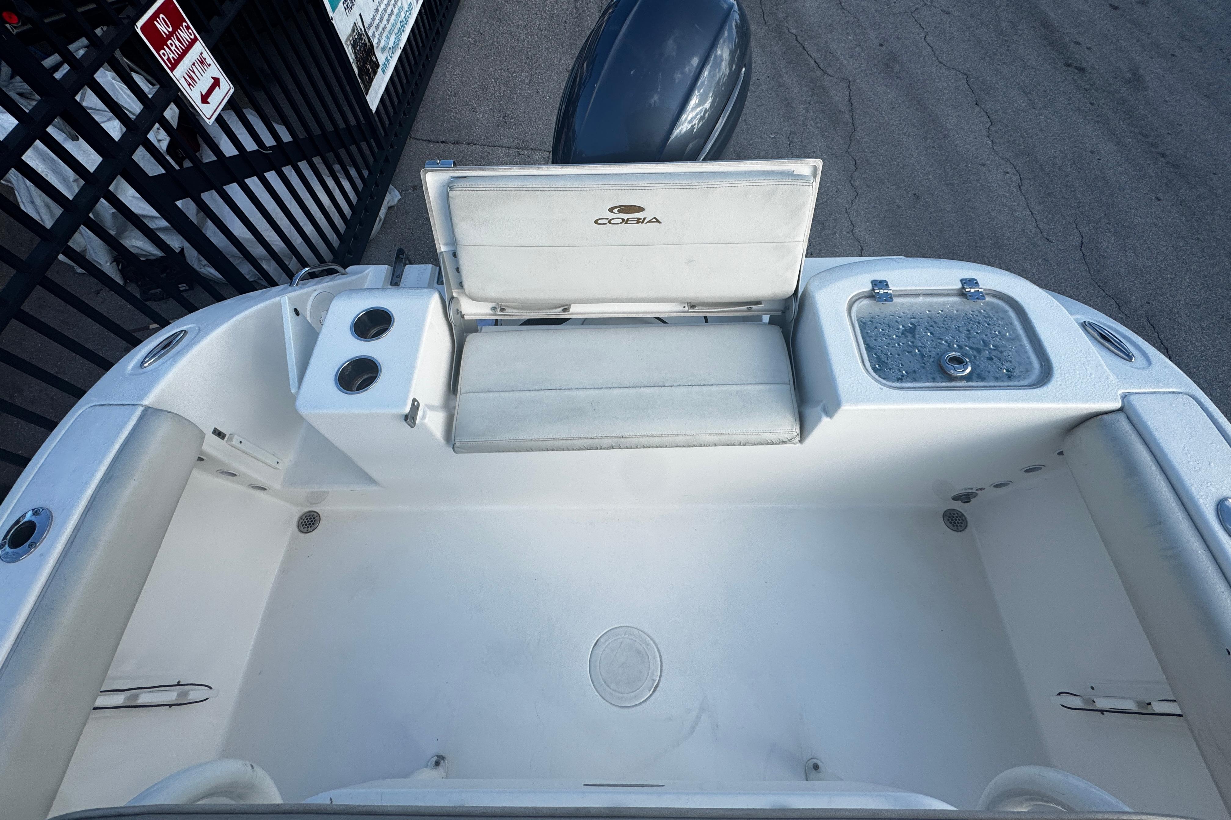 2021 Cobia 220 Center Console boat interior with seating and storage compartments.