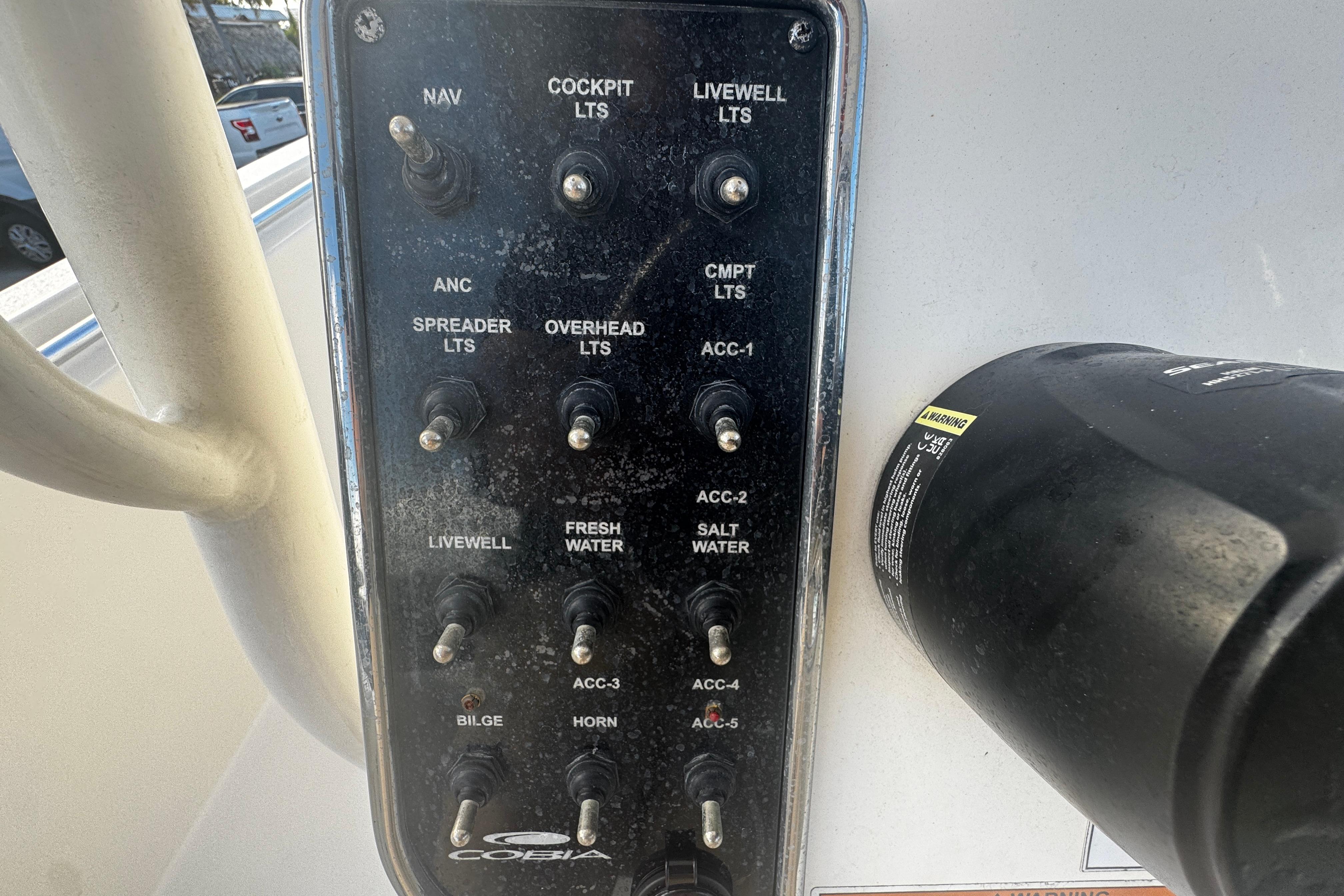 Control panel of a 2021 Cobia 220 Center Console boat with labeled switches.