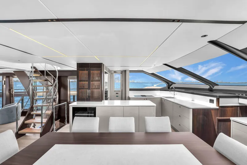 Worth The Wait Yacht Photos Pics Luxurious interior of 2024 Sunseeker Ocean 182 yacht with modern kitchen and ocean view.
