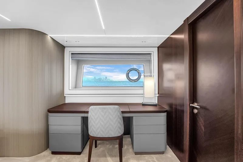 Worth The Wait Yacht Photos Pics Luxurious Sunseeker Ocean 182 yacht interior, featuring a modern desk and ocean view window.