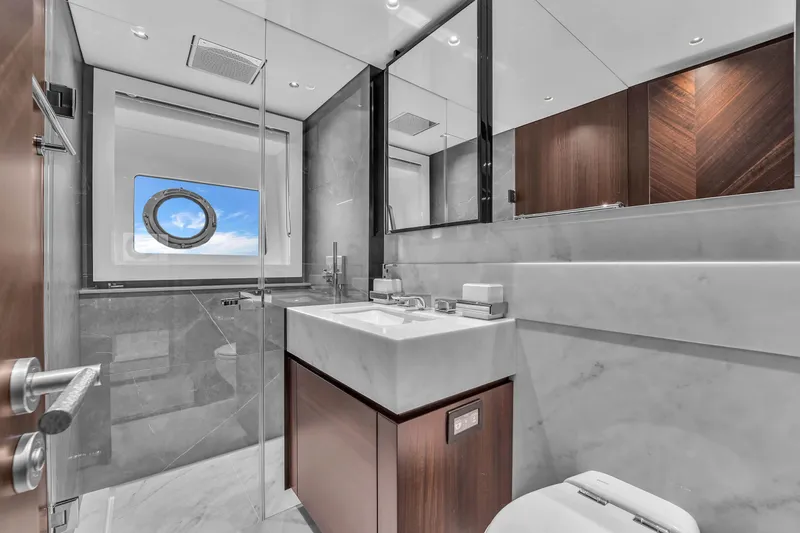 Worth The Wait Yacht Photos Pics Luxurious bathroom in 2024 Sunseeker Ocean 182 yacht, featuring modern fixtures and ocean view.