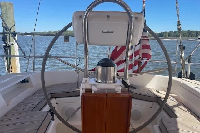 Aquavit Yacht Photos Pics Steering wheel of 2001 Tartan 3700 sailboat with American flag in background.