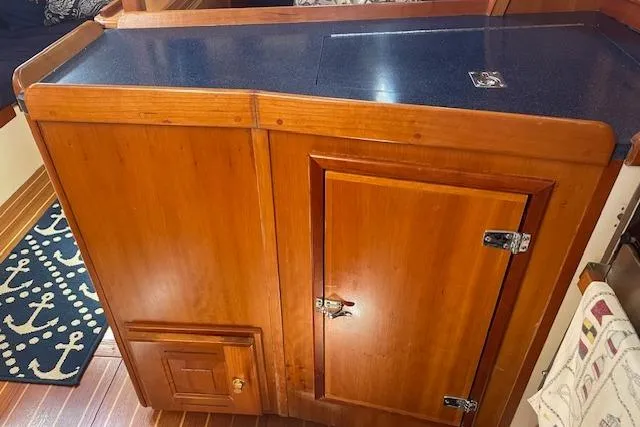 Aquavit Yacht Photos Pics Wooden cabinetry inside a 2001 Tartan 3700 yacht, featuring a dark countertop.