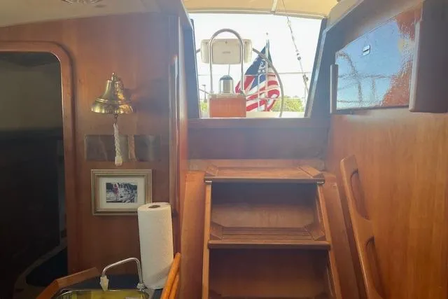 Aquavit Yacht Photos Pics Interior of 2001 Tartan 3700 sailboat with wooden stairs and nautical decor.