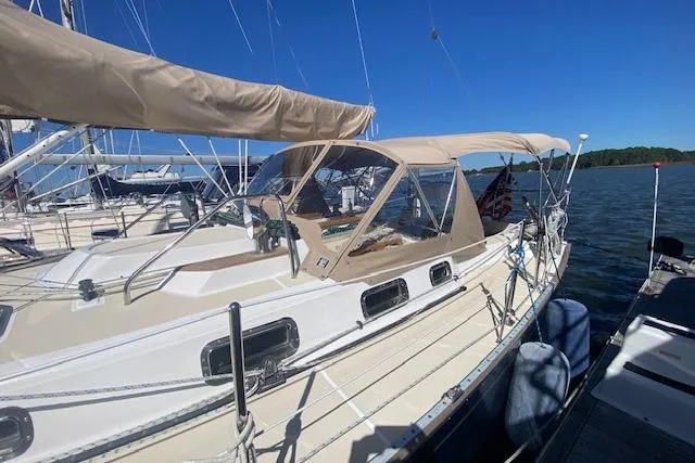 Aquavit Yacht Photos Pics Sailboat Tartan 3700, 2001 model, docked on a sunny day with clear blue skies.