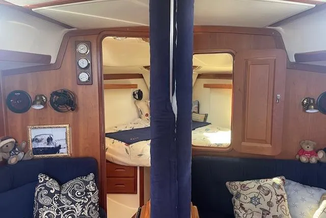 Aquavit Yacht Photos Pics Interior of 2001 Tartan 3700 sailboat with cozy cabin and nautical decor.