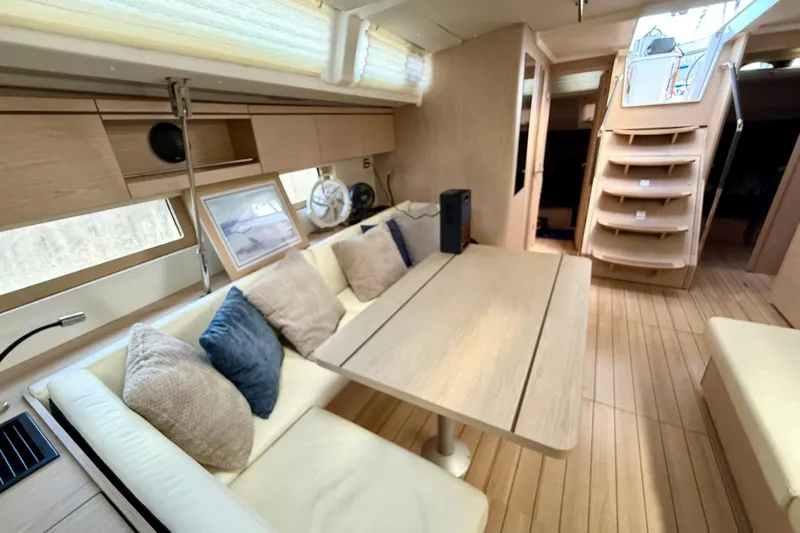  Yacht Photos Pics Luxurious interior of 2020 Beneteau Oceanis 51.1 yacht with modern seating and wooden finishes.