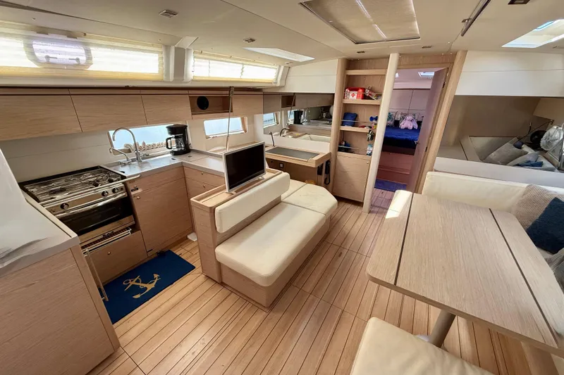  Yacht Photos Pics Luxurious interior of 2020 Beneteau Oceanis 51.1 yacht with modern kitchen and seating area.