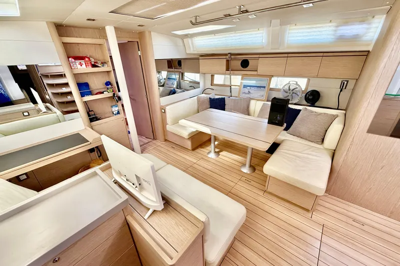  Yacht Photos Pics Luxurious interior of 2020 Beneteau Oceanis 51.1 yacht with modern seating and wooden finishes.