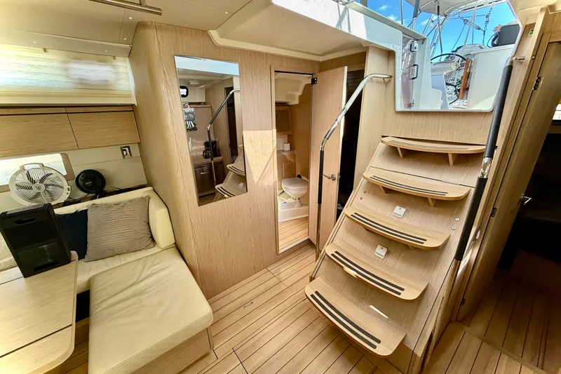  Yacht Photos Pics Interior of 2020 Beneteau Oceanis 51.1 yacht, featuring modern wood finish and cozy seating.