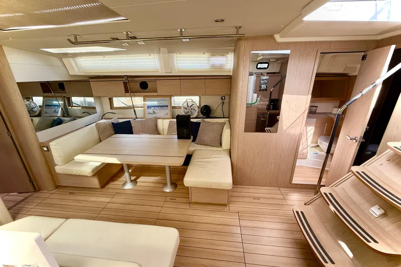  Yacht Photos Pics Luxurious interior of 2020 Beneteau Oceanis 51.1 yacht with modern seating and wooden finishes.