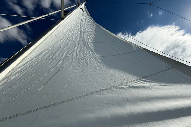  Yacht Photos Pics Sail of 2020 Beneteau Oceanis 51.1 yacht against blue sky and clouds.