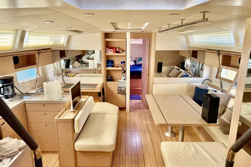  Yacht Photos Pics Interior of 2020 Beneteau Oceanis 51.1 yacht, featuring modern kitchen and cozy seating area.