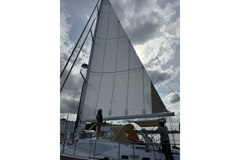  Yacht Photos Pics 2023 Garcia SLOOP ALUMINIUM 51 sailboat with raised sails under cloudy sky.