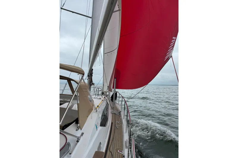  Yacht Photos Pics Sailing on Garcia SLOOP ALUMINIUM 51, 2023 model, with vibrant red sail on open sea.