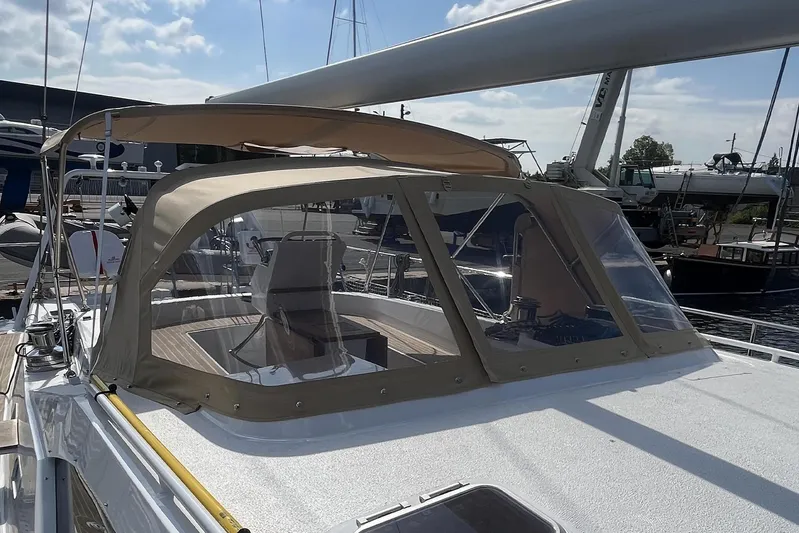  Yacht Photos Pics 2023 Garcia SLOOP ALUMINIUM 51 yacht with beige canopy and clear windows at a marina.