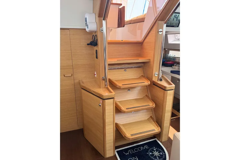  Yacht Photos Pics Interior stairs of 2023 Garcia SLOOP ALUMINIUM 51 yacht, featuring wooden design and welcome mat.