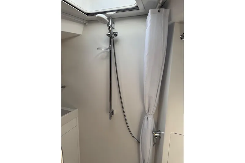  Yacht Photos Pics Shower area in 2023 Garcia SLOOP ALUMINIUM 51 yacht, featuring modern fixtures and curtain.