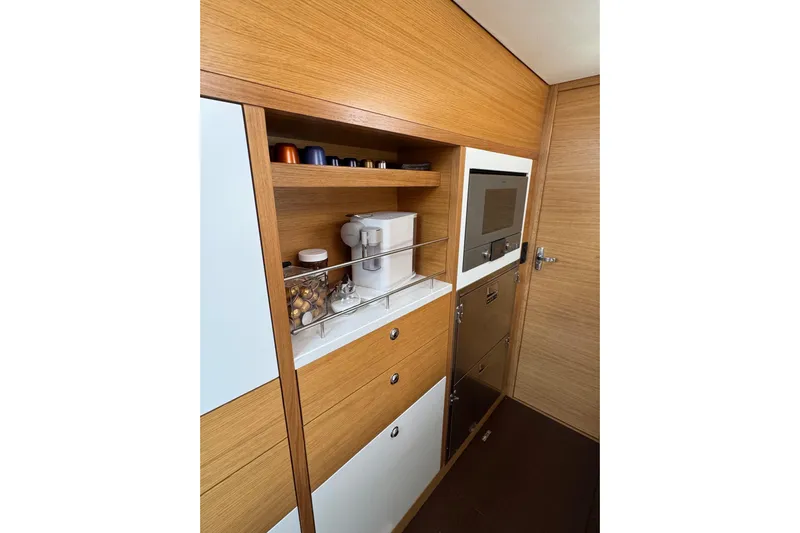  Yacht Photos Pics Modern kitchen interior of 2023 Garcia SLOOP ALUMINIUM 51 yacht with wooden cabinetry.