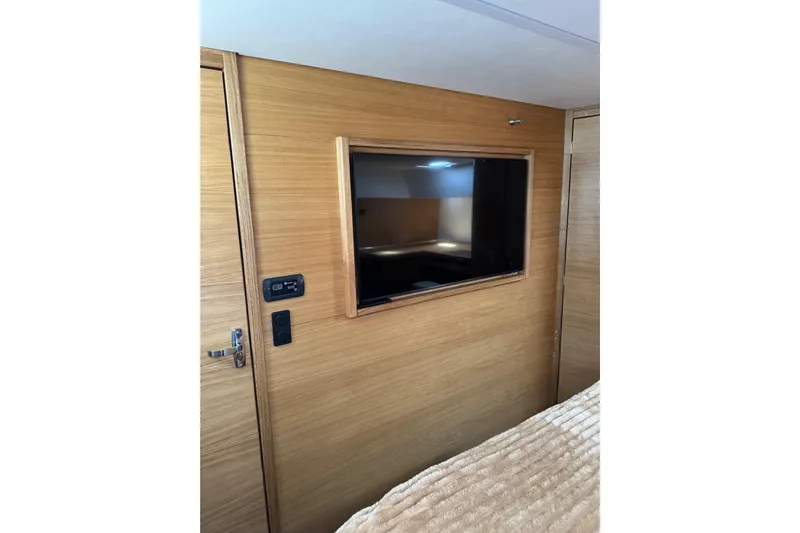  Yacht Photos Pics Interior of 2023 Garcia Sloop Aluminium 51 yacht with wooden paneling and built-in TV.