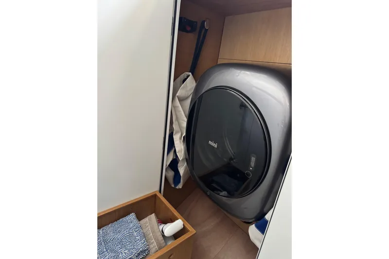  Yacht Photos Pics Compact laundry area on Garcia SLOOP ALUMINIUM 51 yacht, featuring a mini washing machine.
