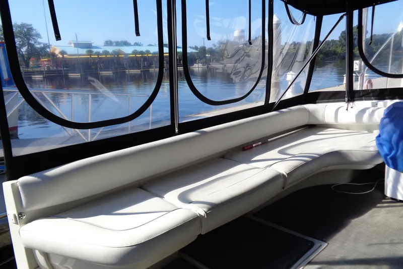 Snri Yacht Photos Pics Interior view of 1991 Sea Ray 480 Sundancer yacht with white seating and waterfront backdrop.