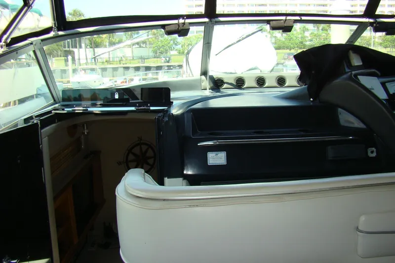 Snri Yacht Photos Pics Interior view of a 1991 Sea Ray 480 Sundancer yacht cockpit, featuring steering and seating.