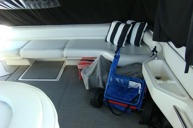 Snri Yacht Photos Pics Interior of 1991 Sea Ray 480 Sundancer with seating, striped pillows, and storage.