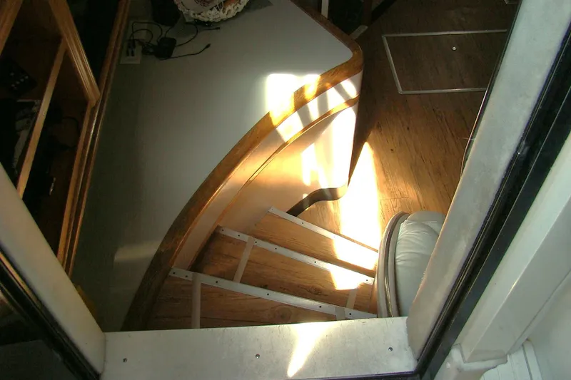 Snri Yacht Photos Pics Interior stairs of 1991 Sea Ray 480 Sundancer yacht, featuring wooden steps and sunlight.