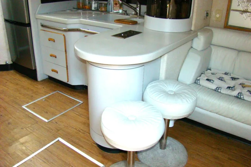 Snri Yacht Photos Pics Interior of 1991 Sea Ray 480 Sundancer yacht with kitchen and seating area.