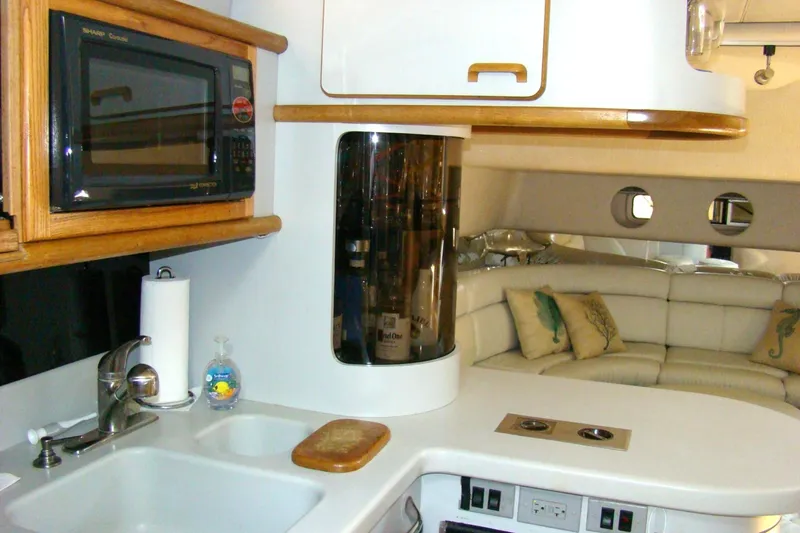 Snri Yacht Photos Pics Interior of 1991 Sea Ray 480 Sundancer yacht with kitchen and seating area.