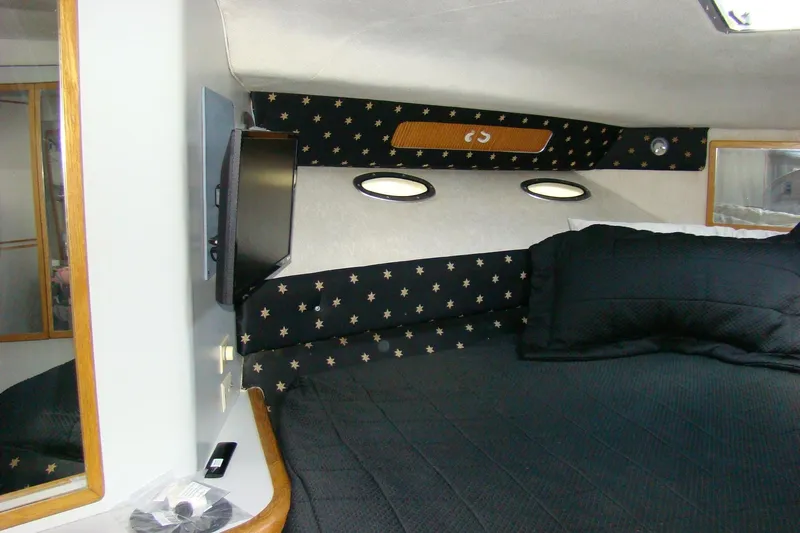 Snri Yacht Photos Pics Interior cabin of 1991 Sea Ray 480 Sundancer with black star-patterned upholstery.