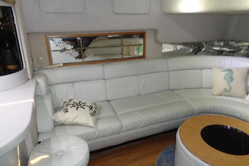 Snri Yacht Photos Pics Luxurious interior of 1991 Sea Ray 480 Sundancer with white leather seating and nautical decor.