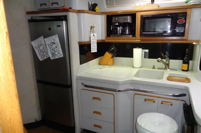Snri Yacht Photos Pics 1991 Sea Ray 480 Sundancer kitchen with appliances, sink, and storage.