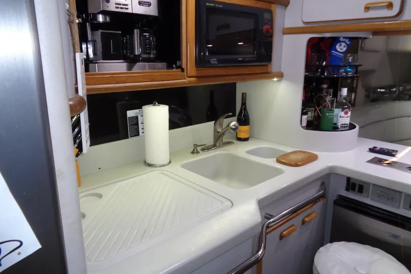 Snri Yacht Photos Pics Compact kitchen area in a 1991 Sea Ray 480 Sundancer yacht with modern appliances.