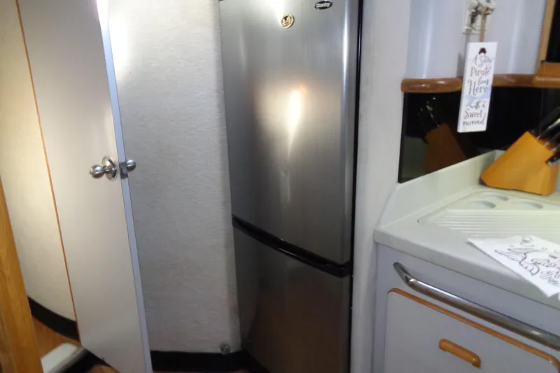 Snri Yacht Photos Pics Interior of 1991 Sea Ray 480 Sundancer with stainless steel fridge and kitchen counter.