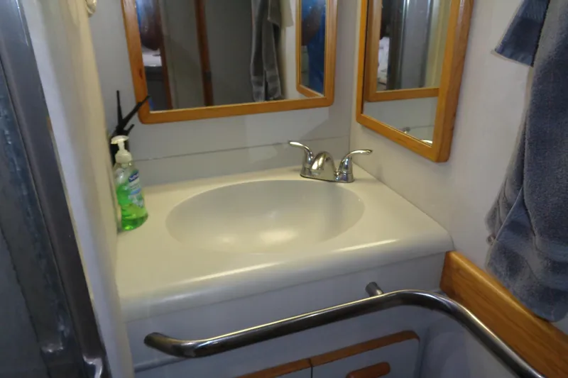 Snri Yacht Photos Pics Bathroom sink area on 1991 Sea Ray 480 Sundancer yacht with mirror and hand soap.