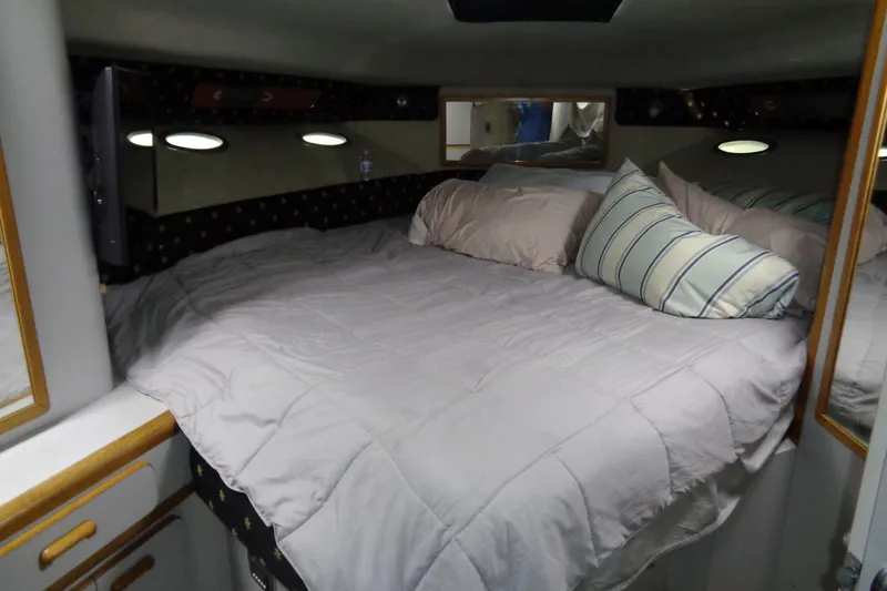 Snri Yacht Photos Pics Cozy bedroom interior of 1991 Sea Ray 480 Sundancer yacht with plush bedding.
