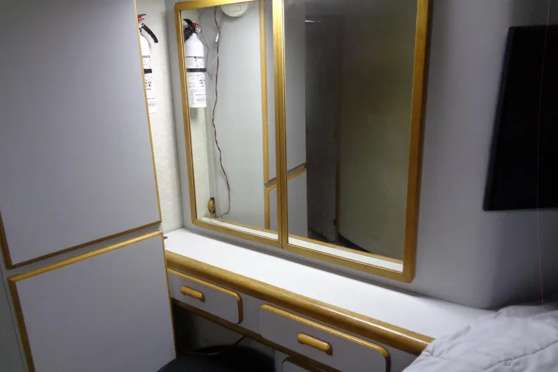 Snri Yacht Photos Pics Vanity area in 1991 Sea Ray 480 Sundancer with mirror and fire extinguishers.