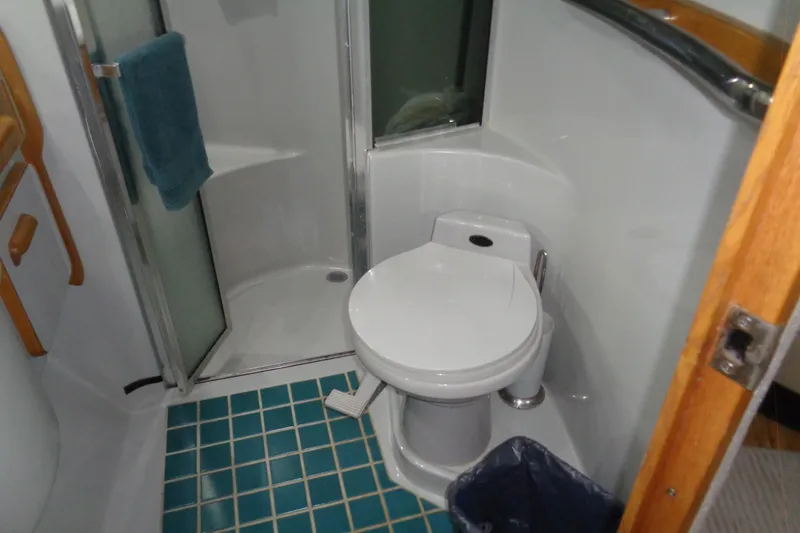Snri Yacht Photos Pics Bathroom interior of 1991 Sea Ray 480 Sundancer yacht with shower and toilet.