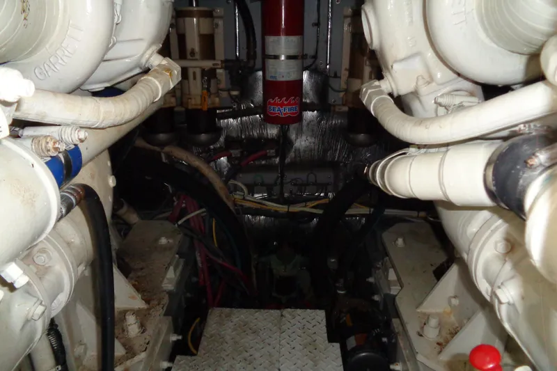 Snri Yacht Photos Pics Engine room of 1991 Sea Ray 480 Sundancer with visible piping and fire extinguisher.