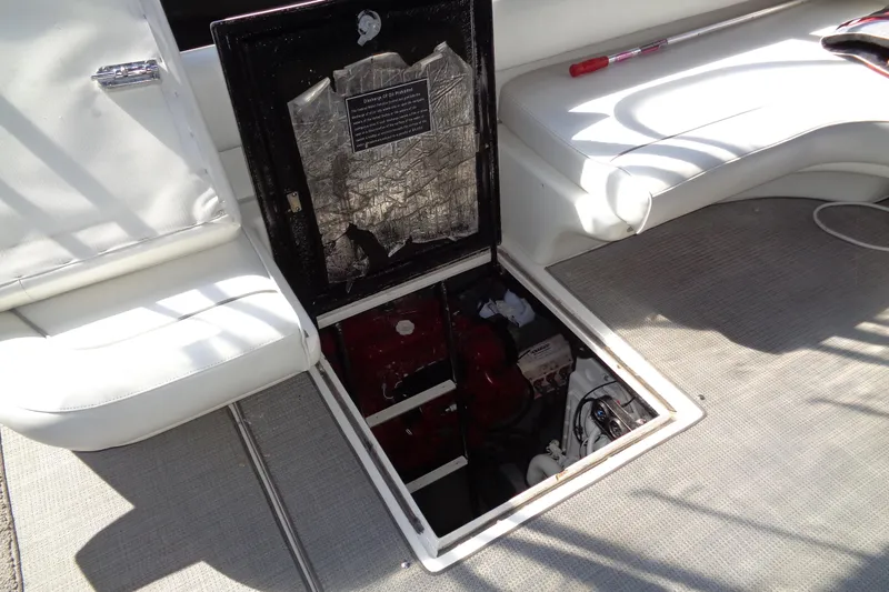 Snri Yacht Photos Pics Engine compartment of 1991 Sea Ray 480 Sundancer with open hatch and white seating.